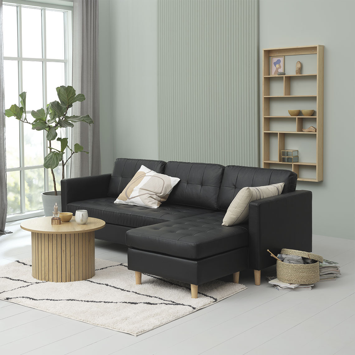 FALSLEV chaise lounge sofa Black chaise lounge sofa in faux leather arranged with wooden furniture