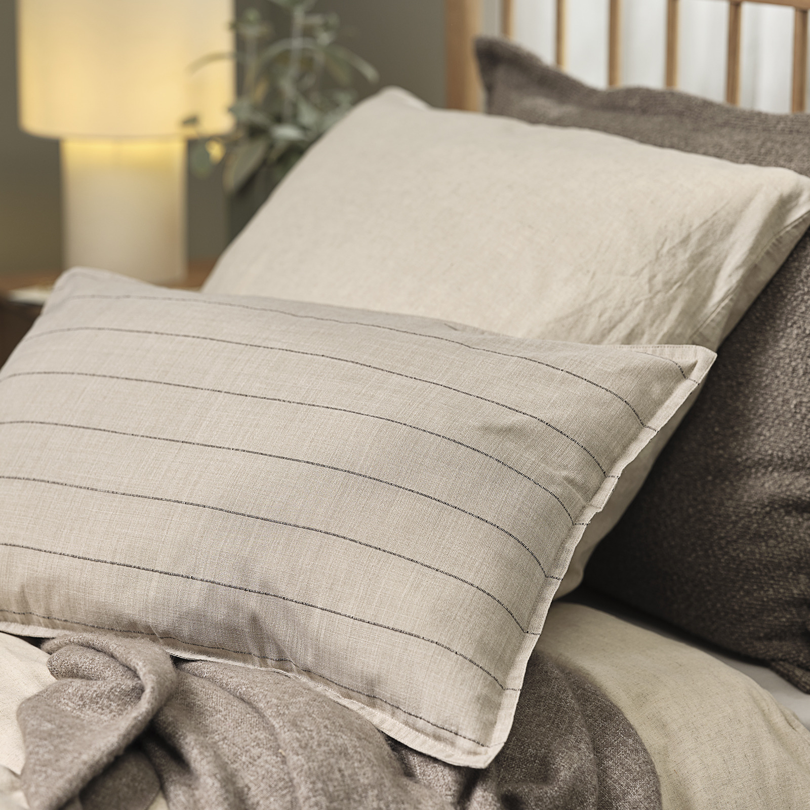 Housse de coussin POPPEL à rayures sable et marron Lit avec deux coussins